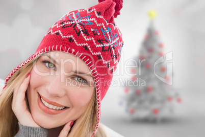 Composite image of smiling woman wearin hat