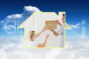 Composite image of couple decorating their new house