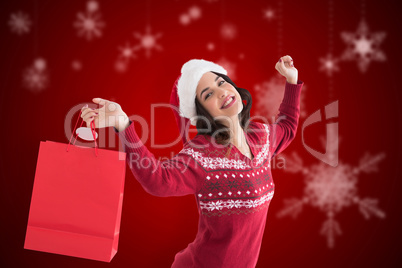 Composite image of content brunette holding shopping bag