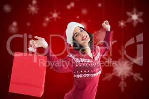 Composite image of content brunette holding shopping bag