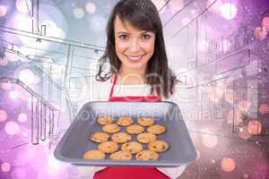 Composite image of festive brunette offering hot cookies