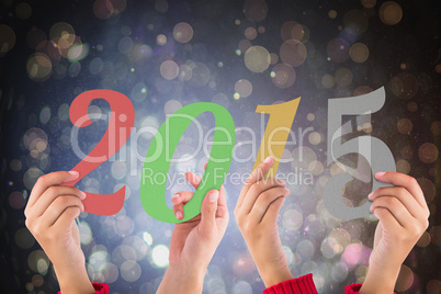 Composite image of hands holding poster