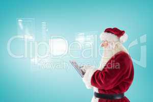 Composite image of santa uses a tablet pc