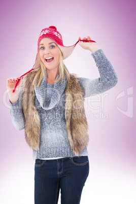 Blonde in winter clothes smiling at camera
