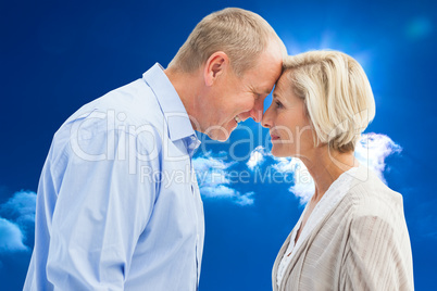 Composite image of happy mature couple facing each other