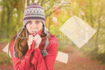Composite image of cold redhead wearing coat and hat