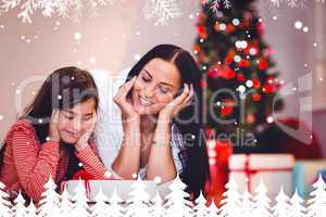 Composite image of festive mother and daughter smiling at gift