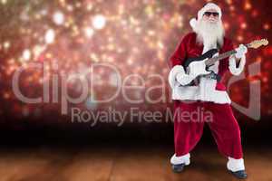 Composite image of santa claus plays guitar with sunglasses