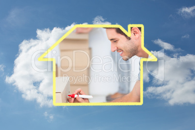 Composite image of man writing withmarker on moving box