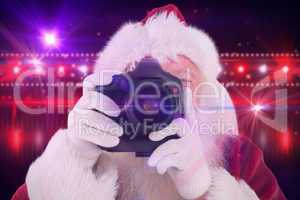 Composite image of santa is taking a picture