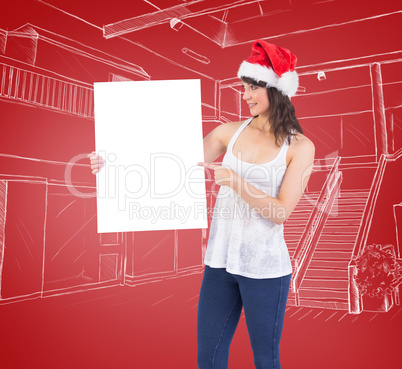 Composite image of pretty girl in santa hat holding poster