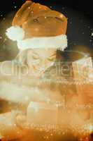 Composite image of pretty brunette in santa outfit opening gift