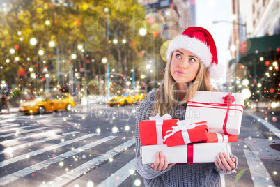 Festive blonde holding pile of gifts