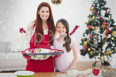 Composite image of festive mother and daughter baking together