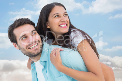 Composite image of happy casual man giving pretty girlfriend pig