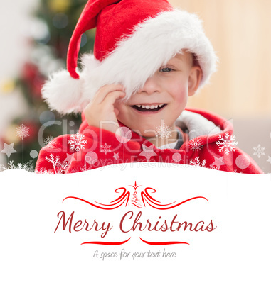 Composite image of festive little boy smiling at camera