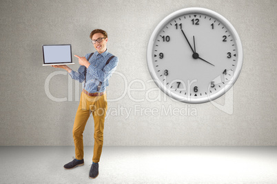 Composite image of geeky businessman showing his laptop