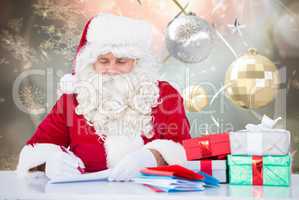 Composite image of santa writing cards