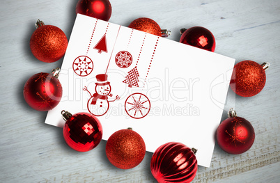 Composite image of hanging red christmas decorations