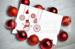 Composite image of hanging red christmas decorations