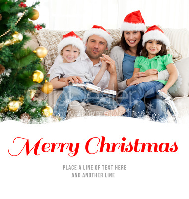 Composite image of portrait of a family at christmas on the sofa