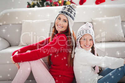 Composite image of mother and daughter smiling at camera