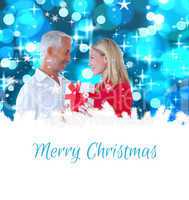 Composite image of loving couple with gift