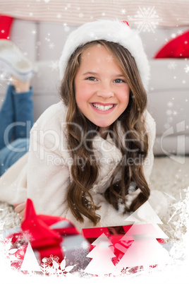 Composite image of festive little girl smiling at camera