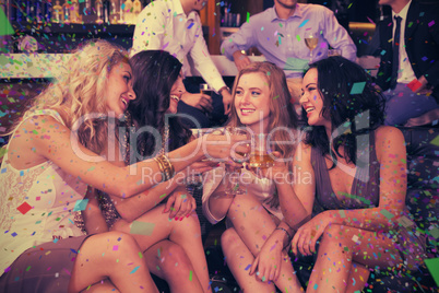 Composite image of pretty friends having a drink together Composite image of pretty friends having a drink together