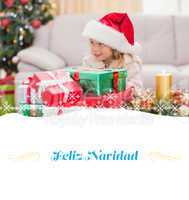 Composite image of cute little girl surrounded by christmas gift