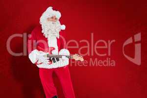 Composite image of happy santa playing electric guitar