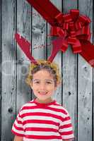 Composite image of cute little boy wearing antlers
