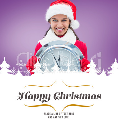 Composite image of festive brunette holding clock