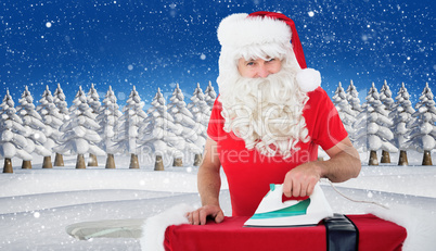 Composite image of happy santa claus ironing his jacket