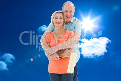 Composite image of happy older couple holding paint roller