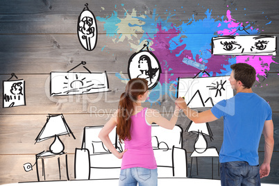 Composite image of couple painting a wall together