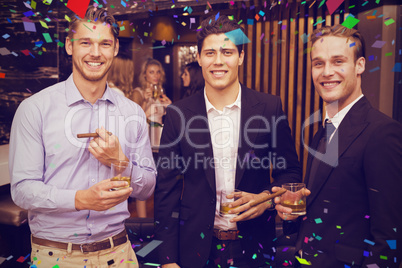 Composite image of handsome friends having a drink together Composite image of handsome friends having a drink together