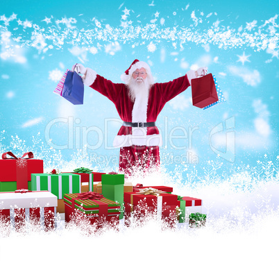 Composite image of santa holds some bags for chistmas