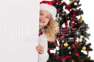 Composite image of festive little girl showing a poster