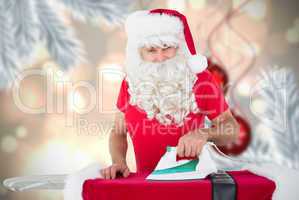 Composite image of happy santa claus ironing his jacket