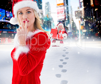 Composite image of festive blonde keeping a secret
