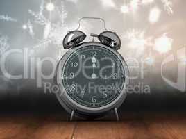 Composite image of alarm clock counting down to twelve