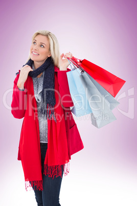 Blonde in winter clothes holding shopping bags