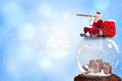 Composite image of santa sitting on snow globe