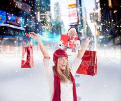 Composite image of pretty blonde carrying shopping bags