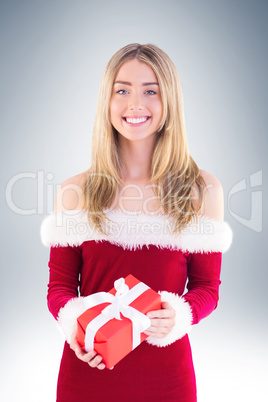 Pretty santa girl holding gift