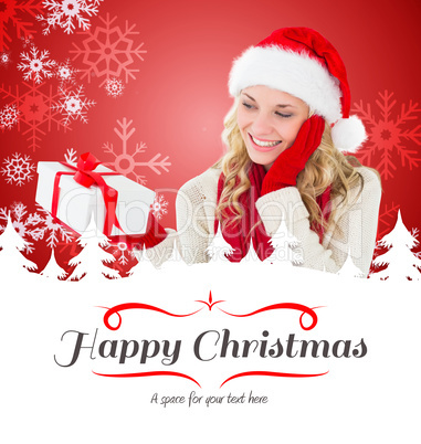 Composite image of happy festive blonde with gift