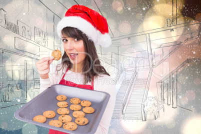 Composite image of brunette in santa hat showing hot cookies