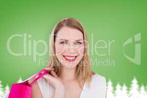 Composite image of portrait of a smiling blonde woman holding sh