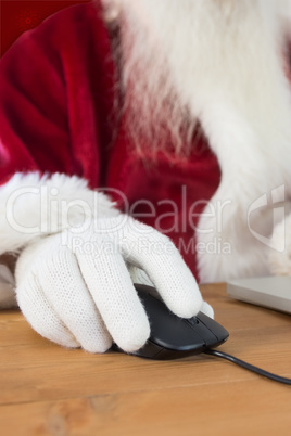 Composite image of santa surfs on the internet